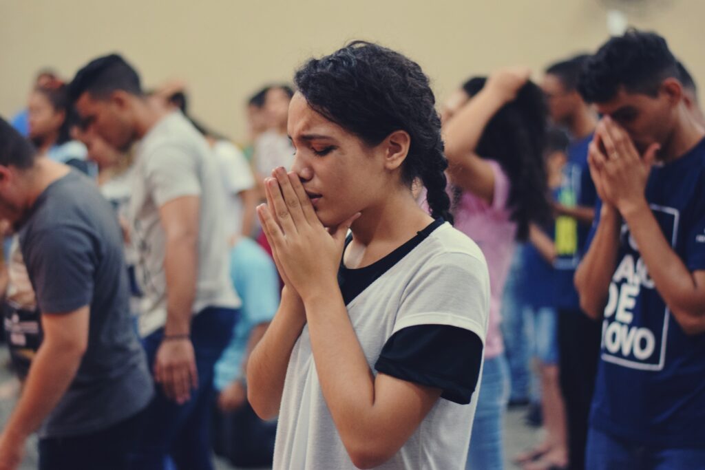 Does prayer work? Woman earnestly praying in church